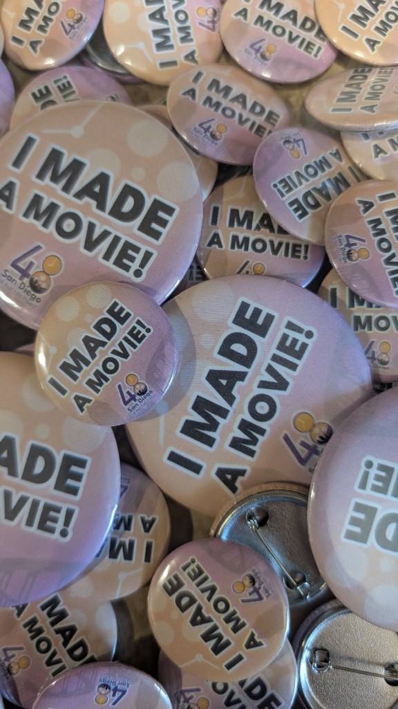 A pile of I MADE A MOVIE pinback buttons from the San Diego 48 Hour Film Project